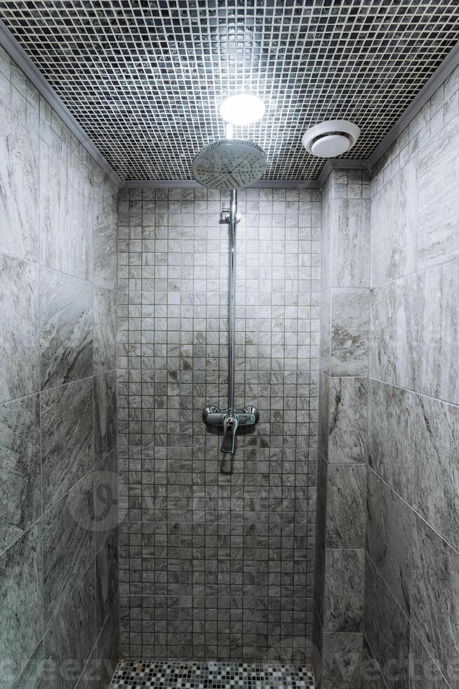 The modern design of a shower stall showcases elegant tiling combined with ambient lighting, creating a soothing and stylish bathroom environment that enhances comfort and promotes relaxation photo