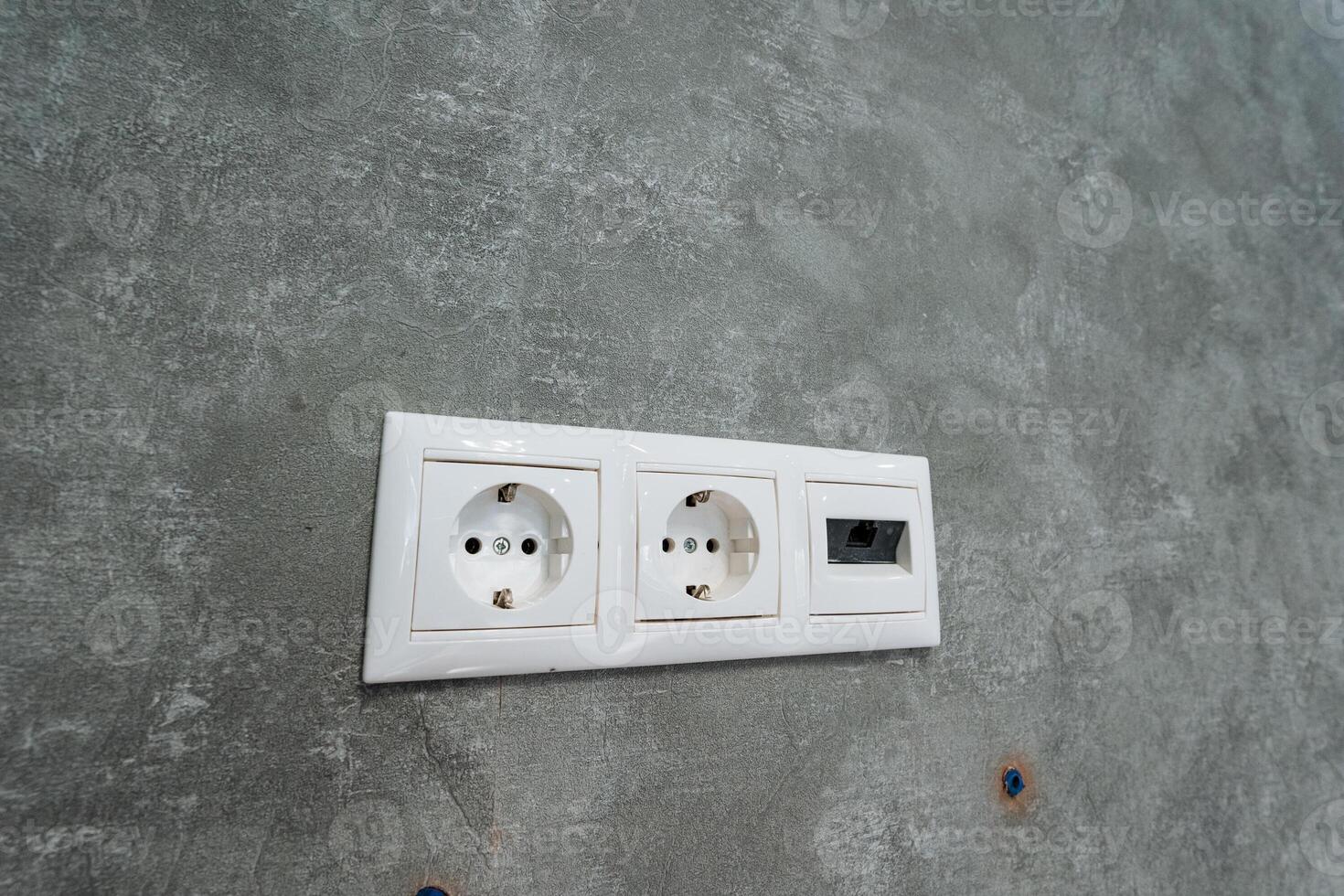 This Modern Electrical Outlet features Dual Sockets along with a convenient USB Port, elegantly installed on a sturdy Concrete Wall, perfect for enhancing your living or working space photo