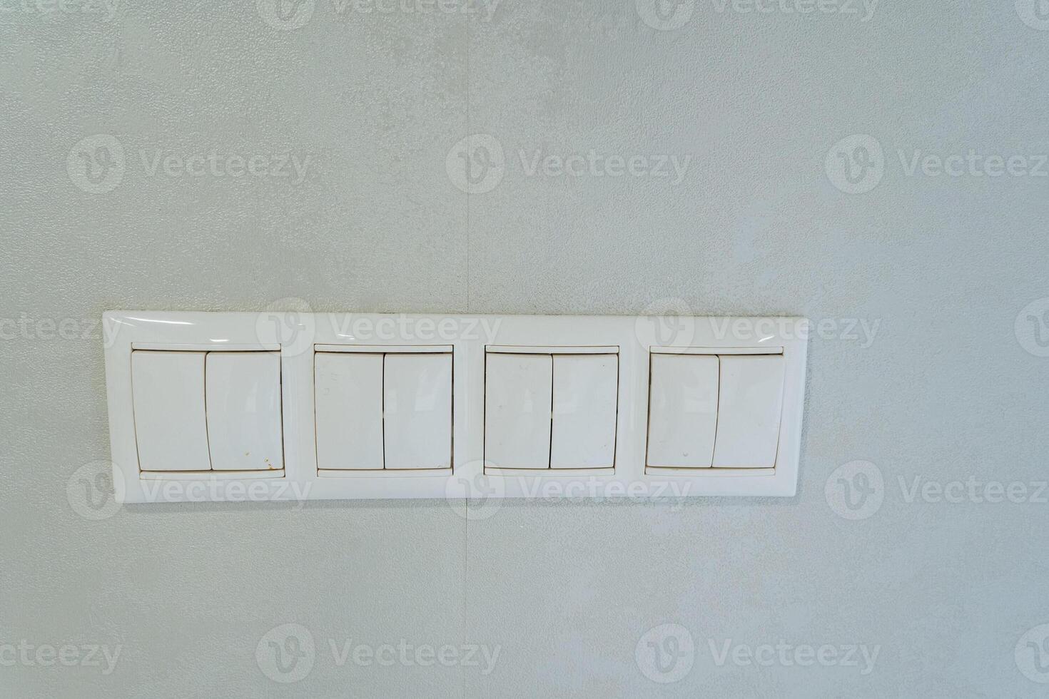 A contemporary modern minimalist light switch panel installed on a flawlessly smooth wall, representing a blend of functionality and aesthetics for a sophisticated residential renovation photo