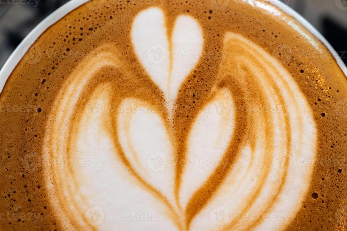 The surface of hot latte coffee. A latte is a coffee drink made with espresso and steamed milk. photo