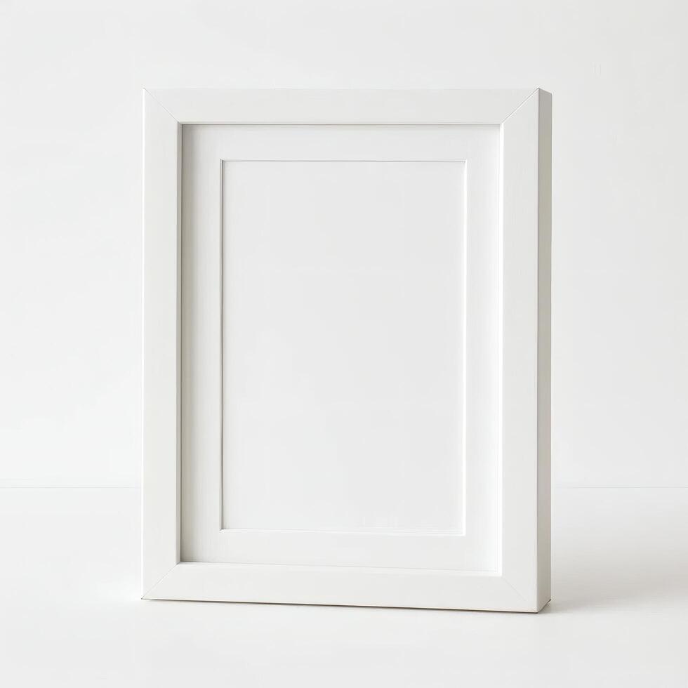 Blank white picture frame on a white surface photo