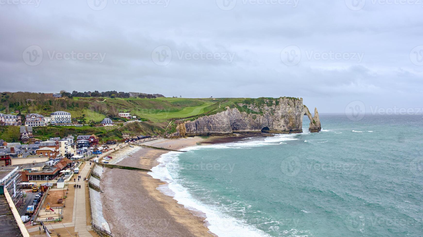 Etretat town and cliffs view from above during overcast day photo