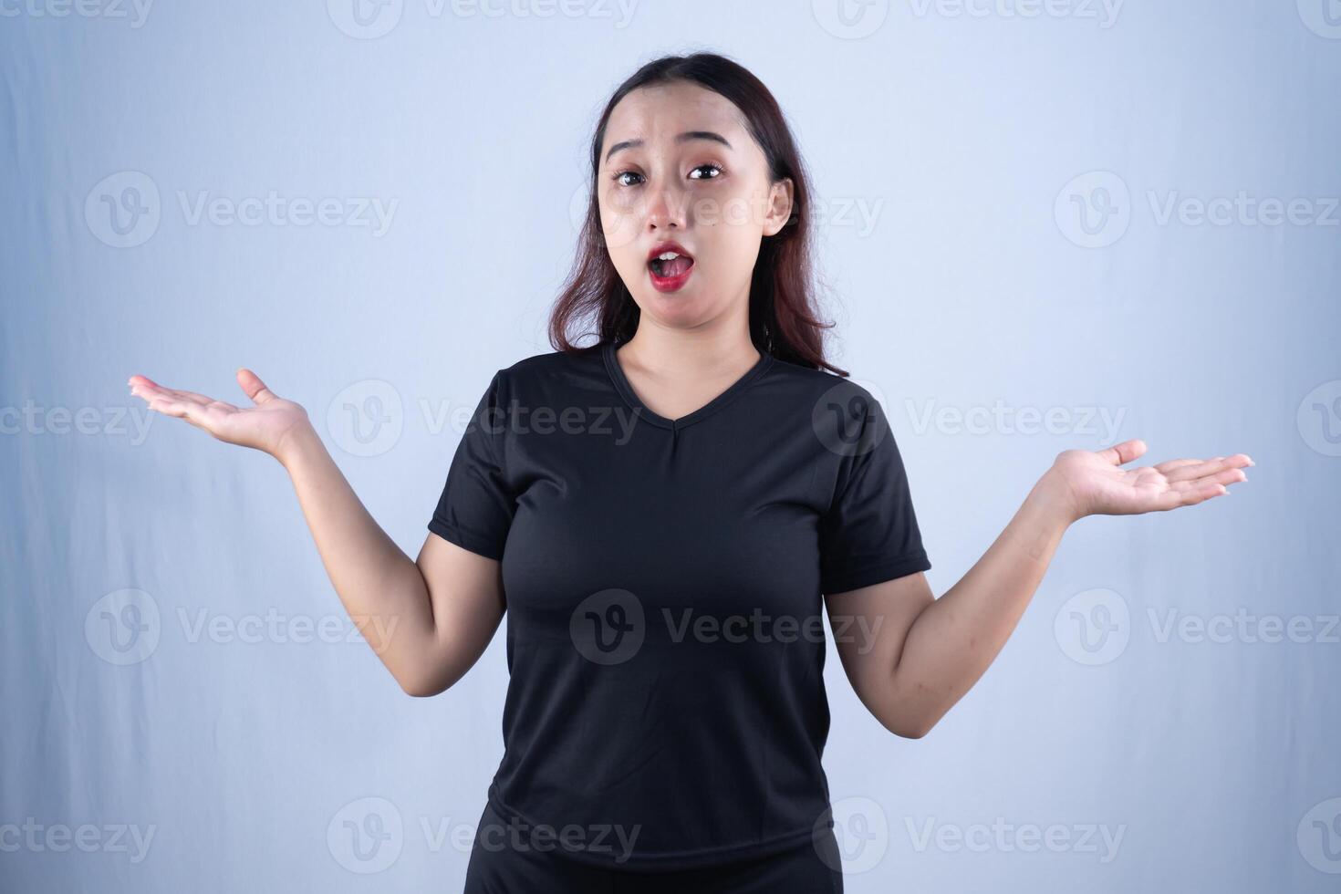 a woman in a black shirt is making a surprised face photo