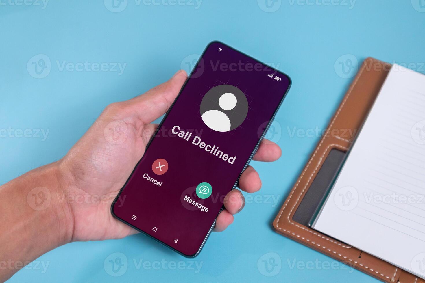 Man holding smartphone with Call Declined screen. Rejected phone call concept. photo
