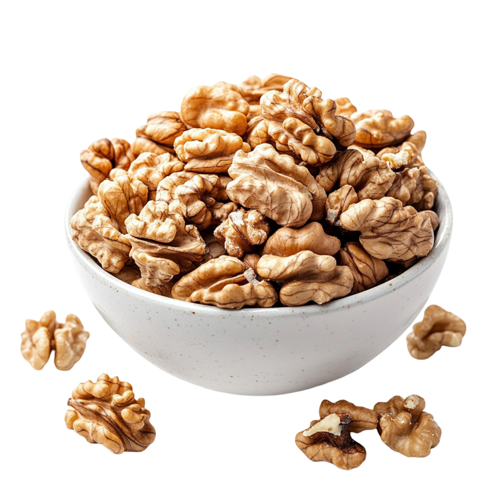A bowl of walnuts with a few nuts scattered around it png