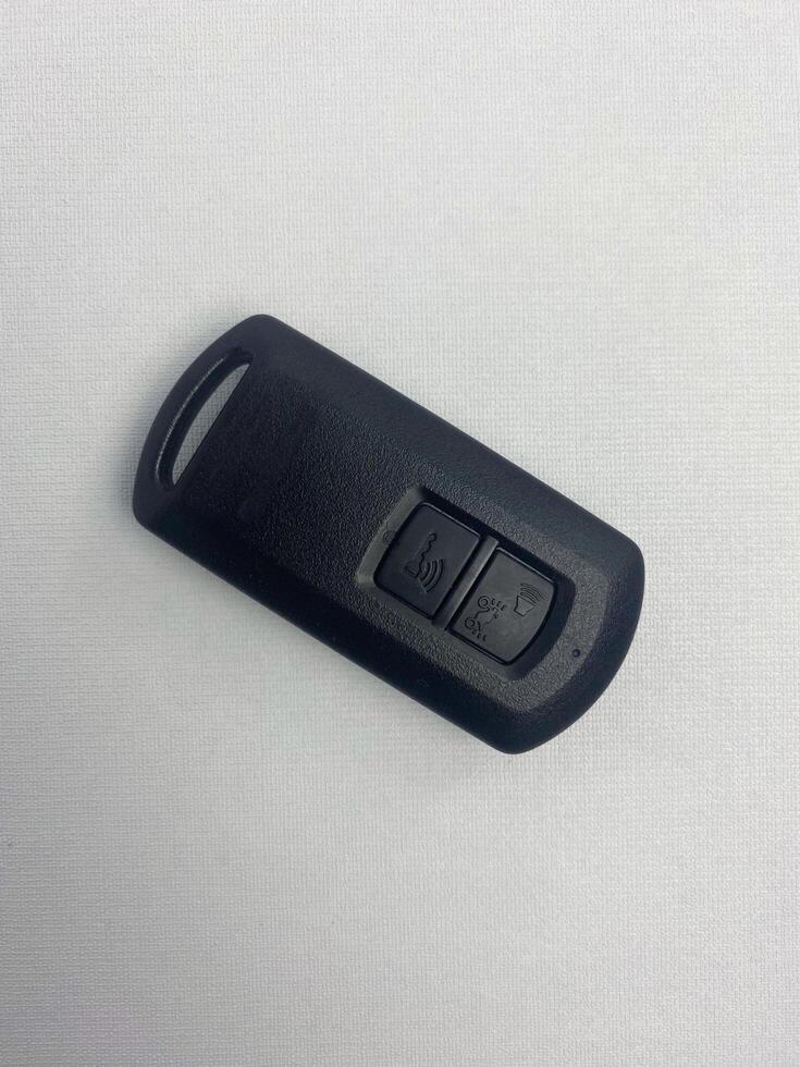 Wireless motorcycle smart key isolated on white background. Keyless remote key for modern vehicles. Devices with buttons lock, standby, and alarm. Shot at a high angle photo