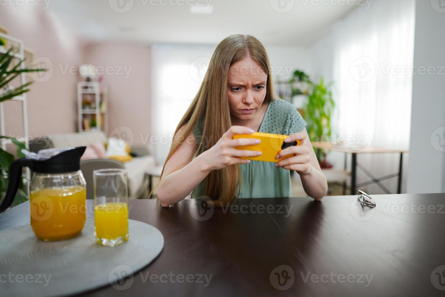Engrossed in a captivating mobile game during a sunny afternoon photo
