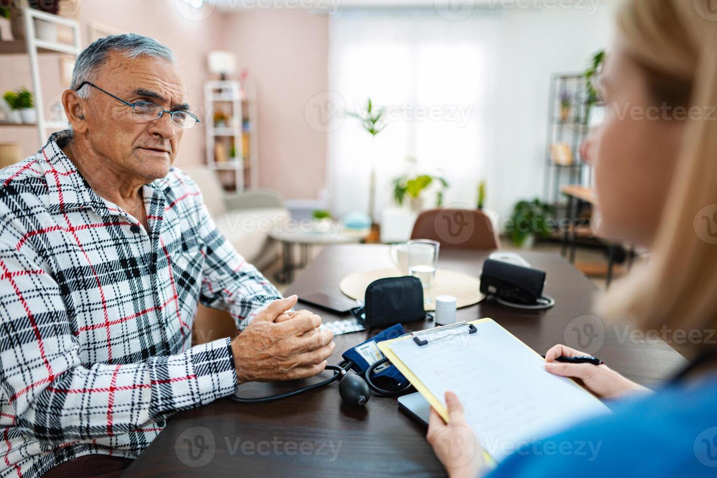 Senior gentleman discusses health concerns with doctor photo