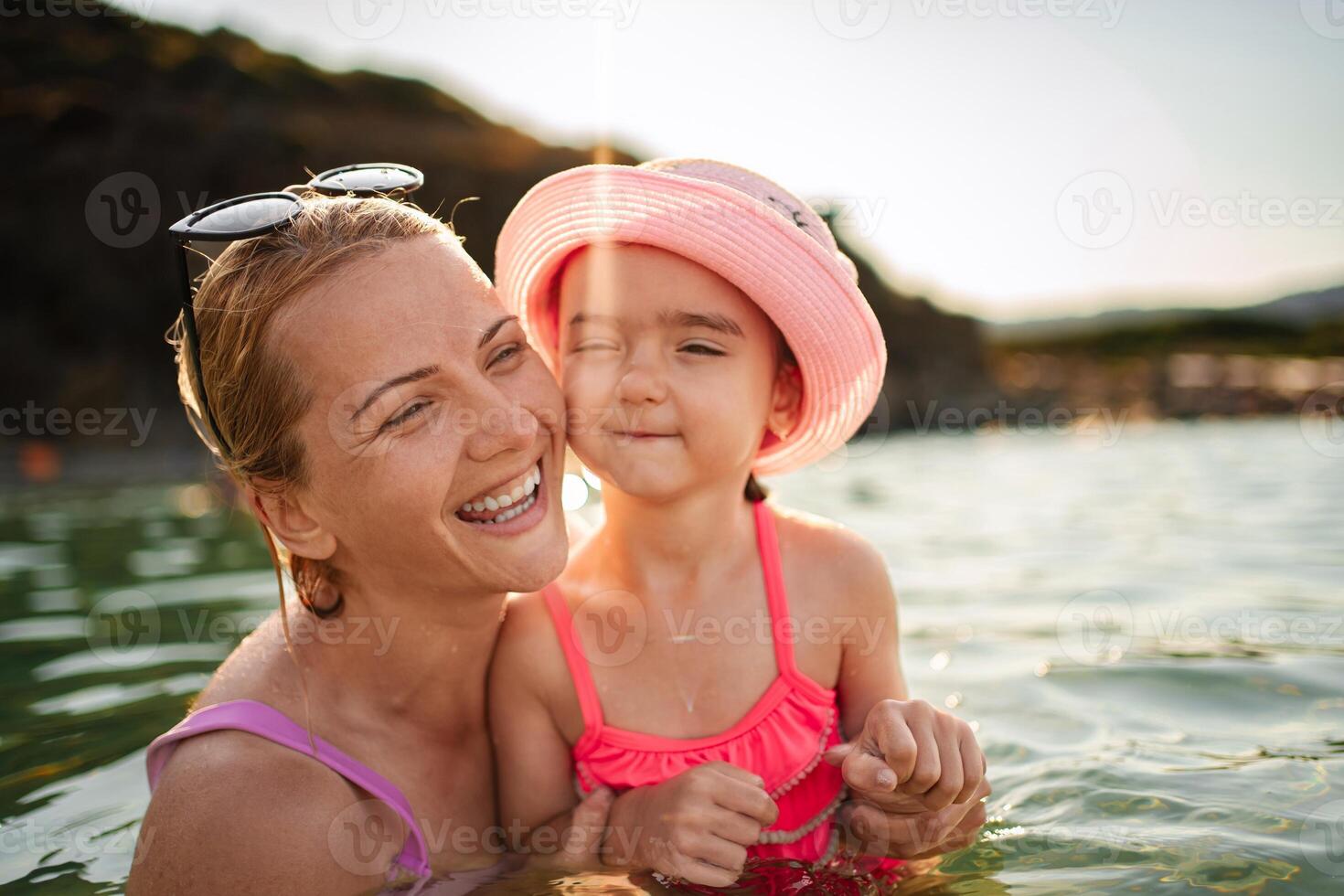 Family enjoys joyful moments together at the serene beach waters photo