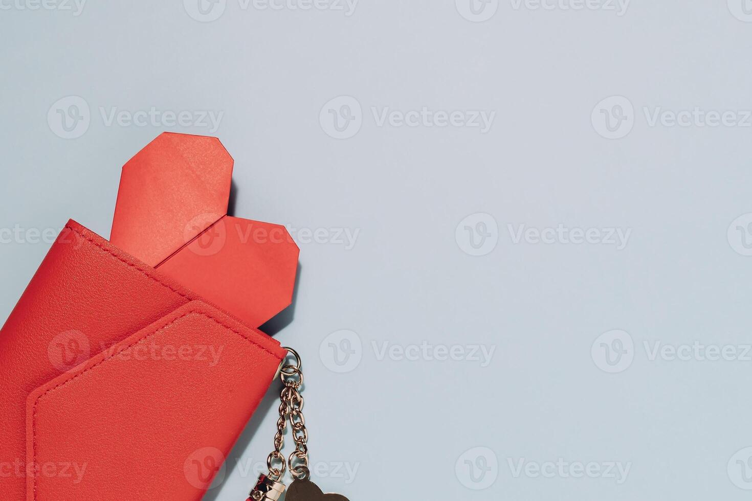 Red Wallet with Heart and Keychain on Blue Background photo