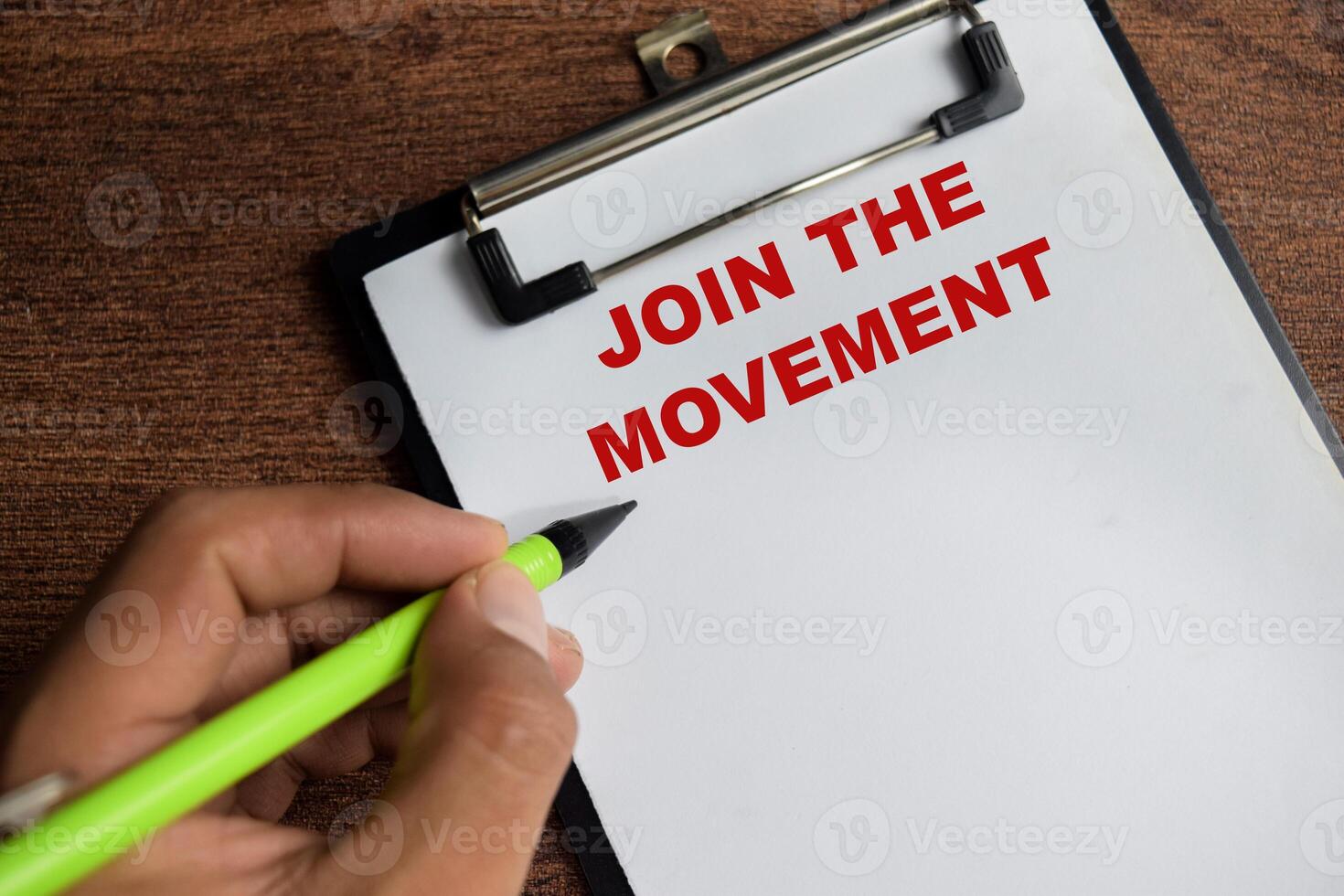 Concept of Join the movement write on clipboard isolated on Wooden Table. photo