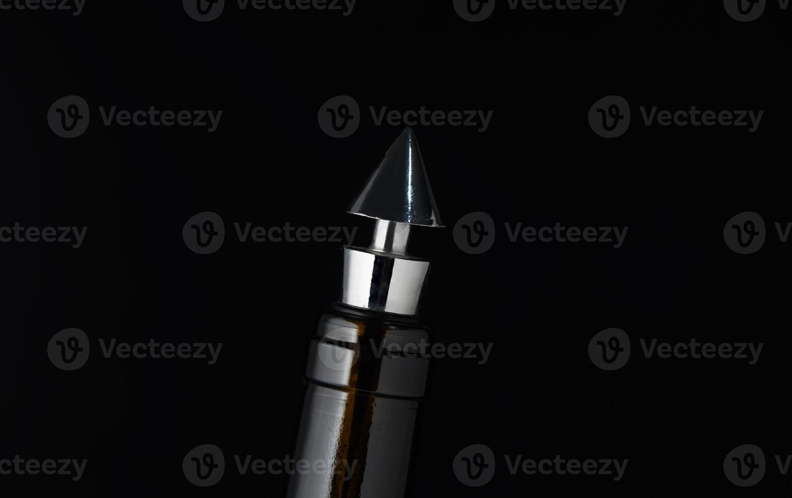 Elegant metallic pen tip shines against dark background, showcasing exquisite craftsmanship close-up photo