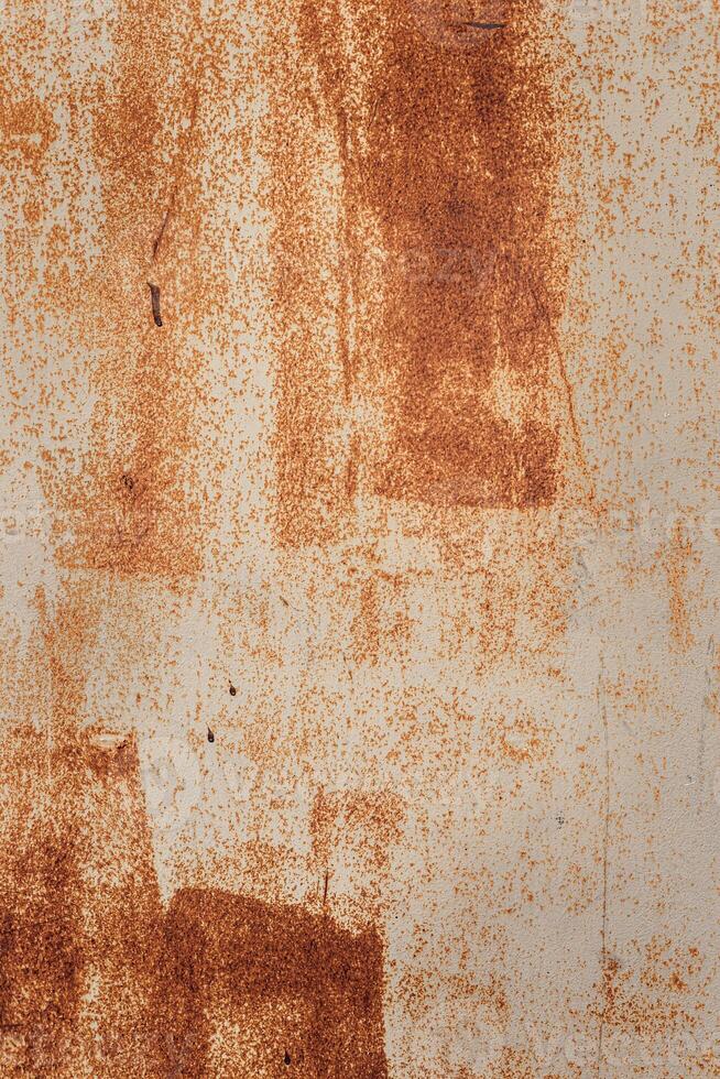 A textured surface with a mix of orange and beige tones. The background features abstract patterns and uneven color distribution, creating a rustic appearance. photo