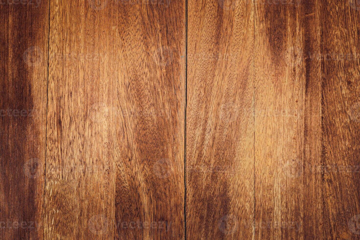 Close-up of wooden surface with rich brown tones and visible grain patterns. texture is smooth and polished photo