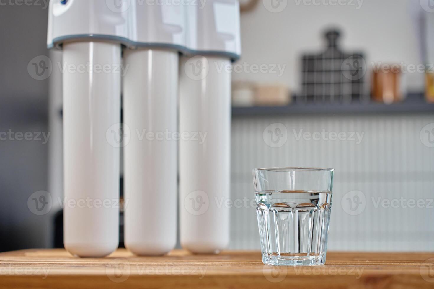 Water filter system and clean water on kitchen table photo