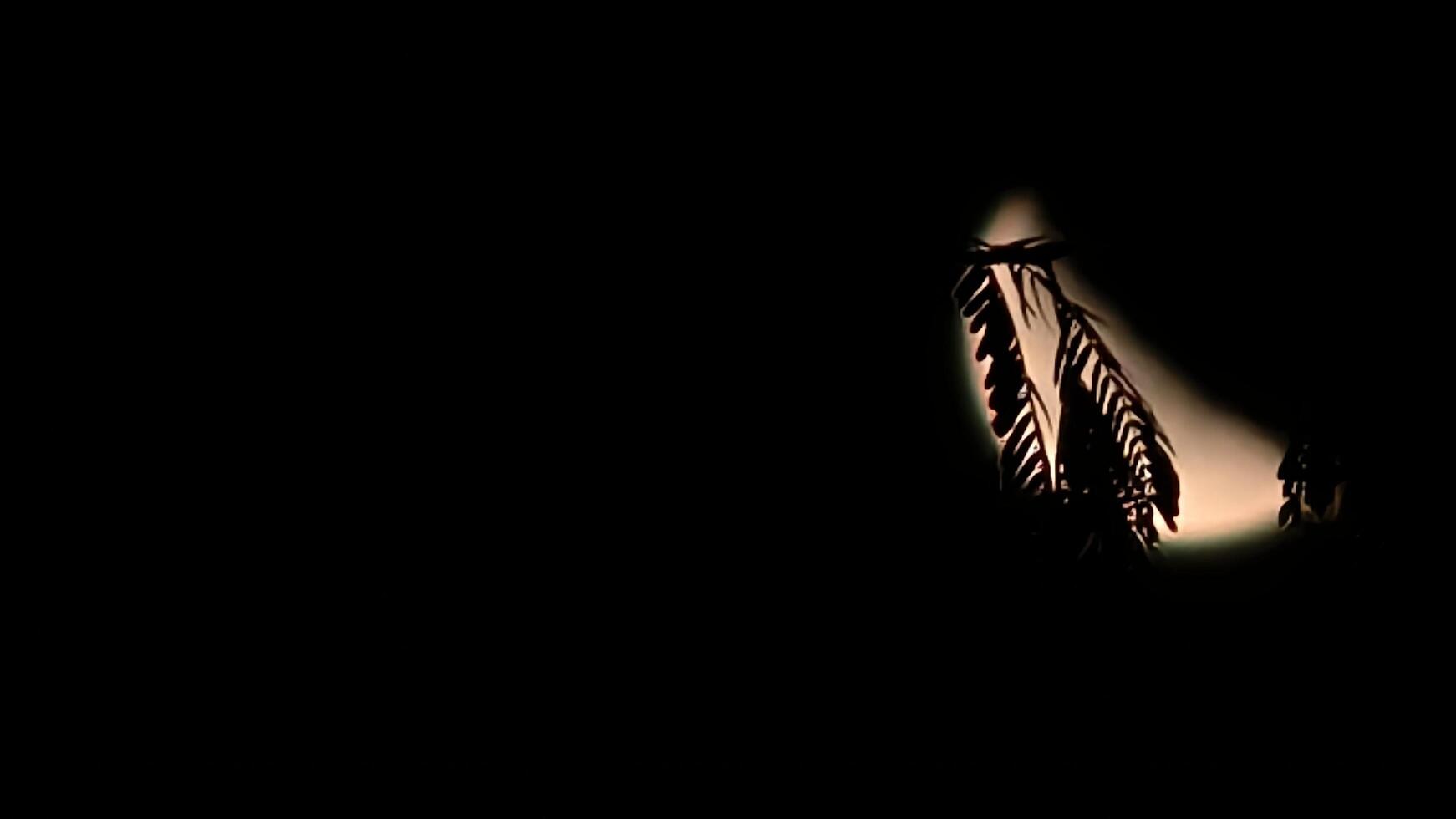 A black background with a light shining through it photo