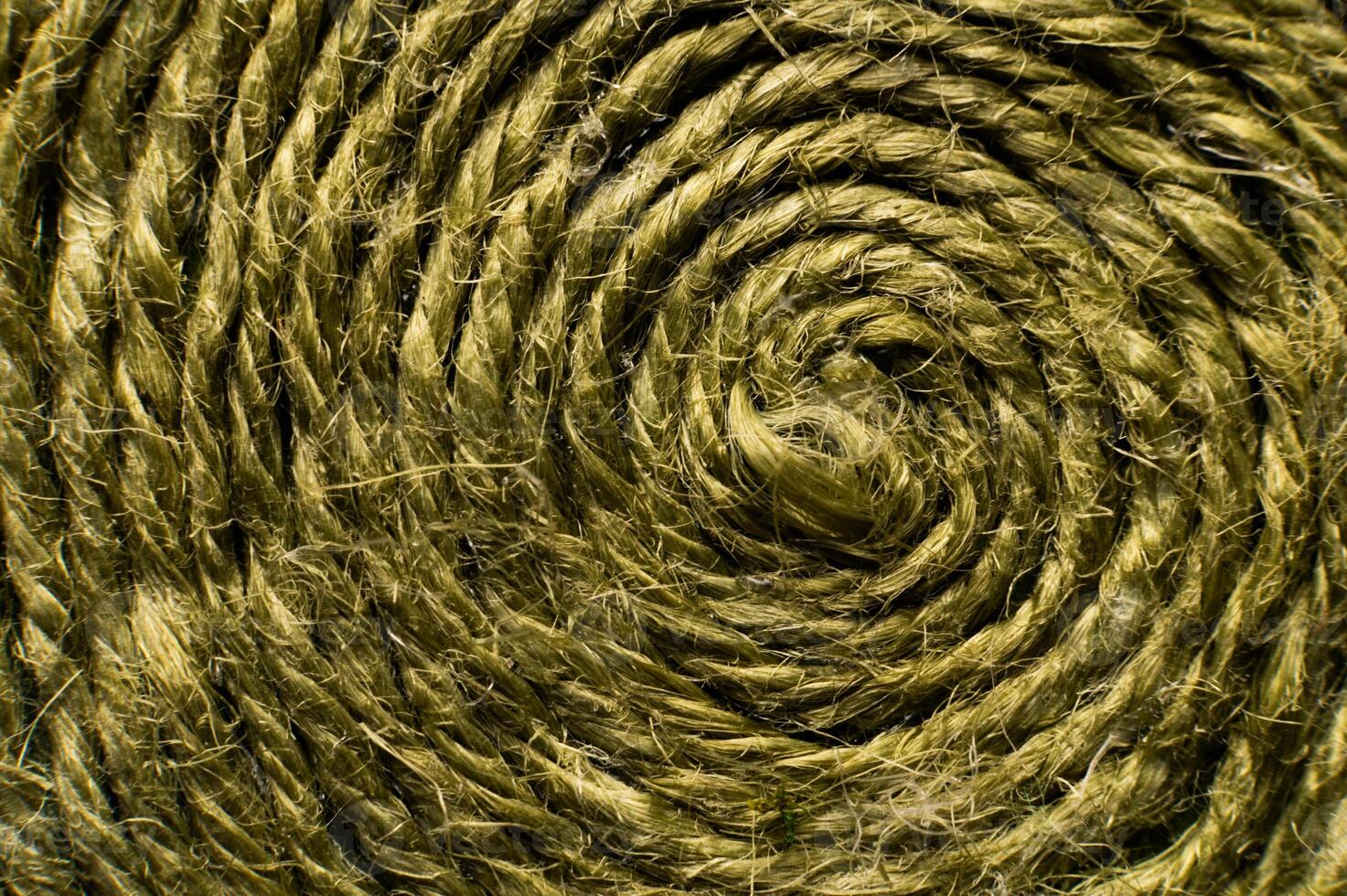 Natural green jute twine close-up. Detailed texture of a roll of coarse thread. Rustic cord background for packaging or crafts. Eco-friendly material for handmade and eco-friendly creativity photo
