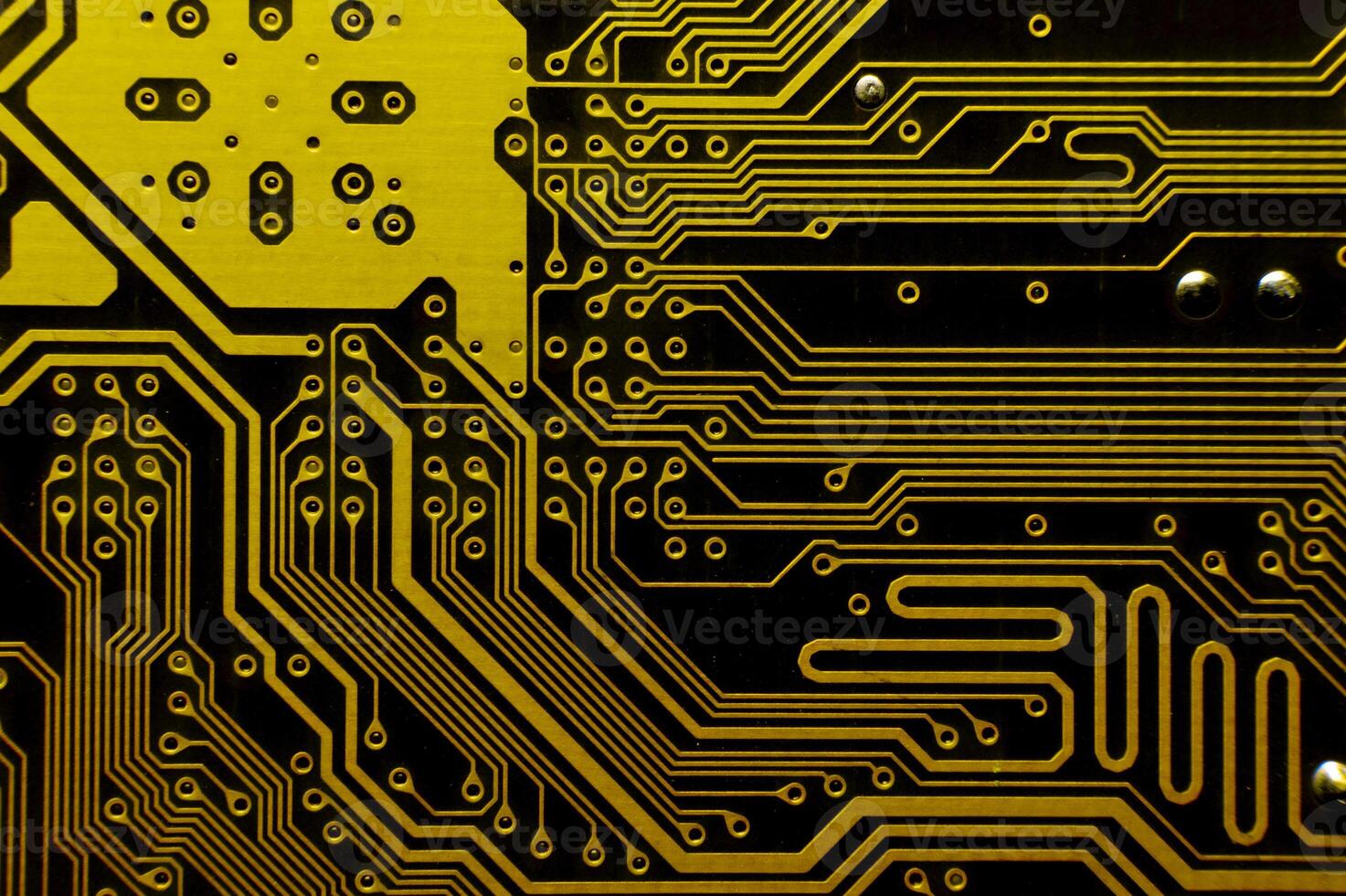 Yellow background of computer motherboard printed circuit board. Macro shot of electronic components photo
