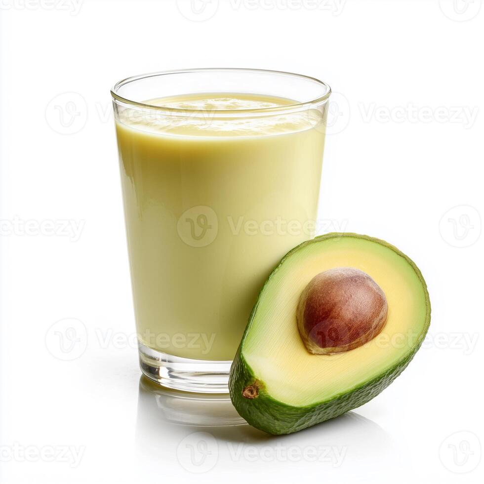 Creamy avocado smoothie with banana, honey, and milk served in a clear glass on a white background photo