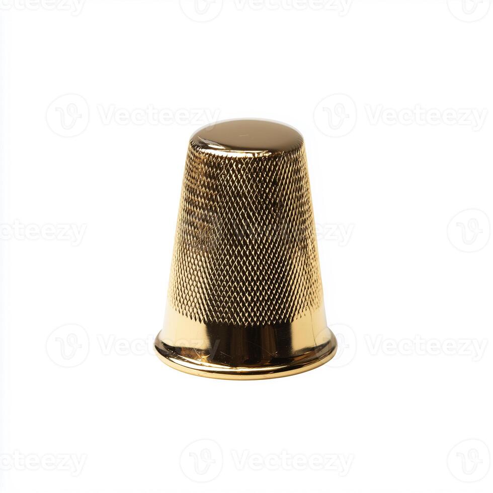 Polished brass sewing thimble isolated on white background for crafting and sewing enthusiasts photo