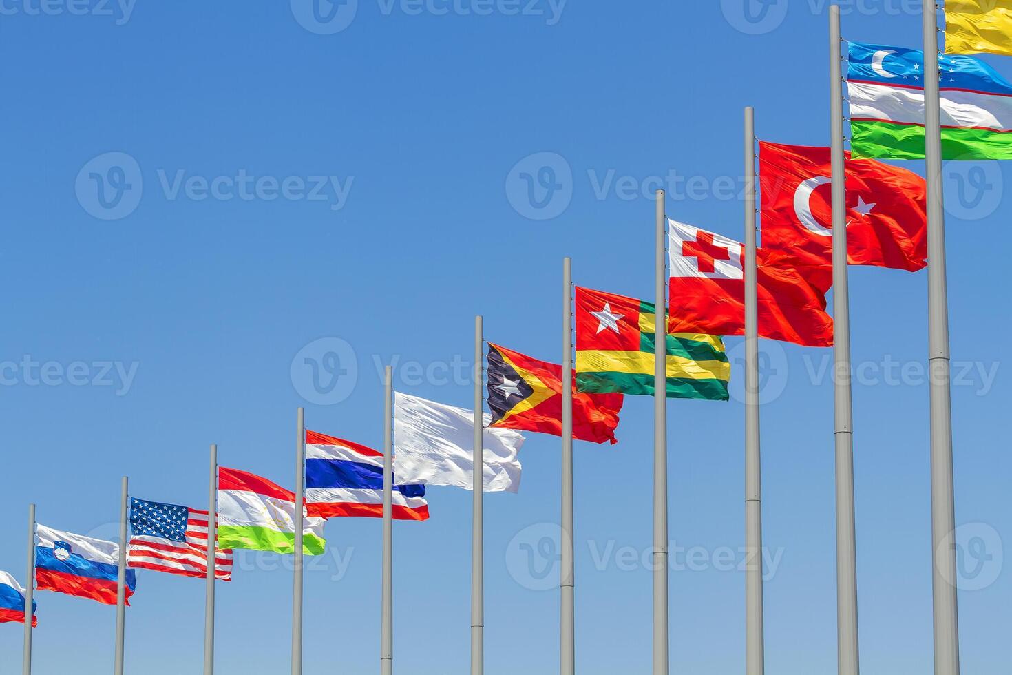 flags of countries against blue sky photo