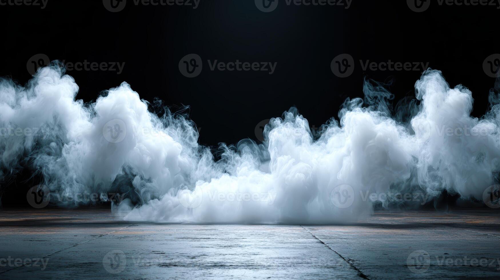 Dense white smoke rolls across textured gray floor against dark background for dramatic effect photo
