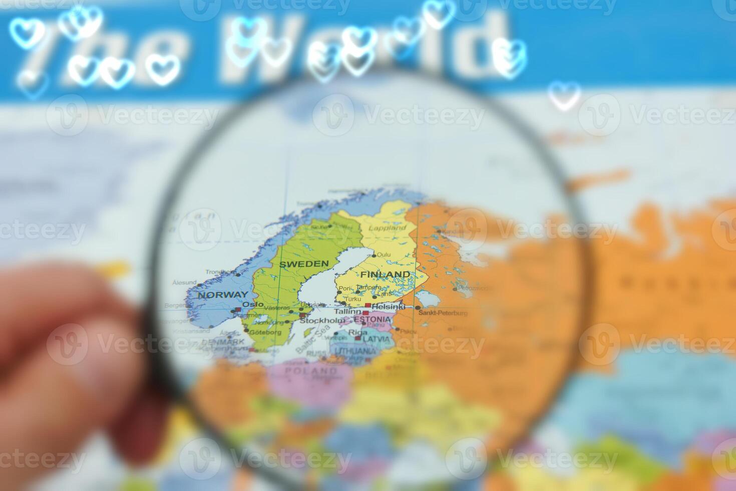 Following the map of northern Europe with a focus on Finland and Sweden through a magnifying glass photo
