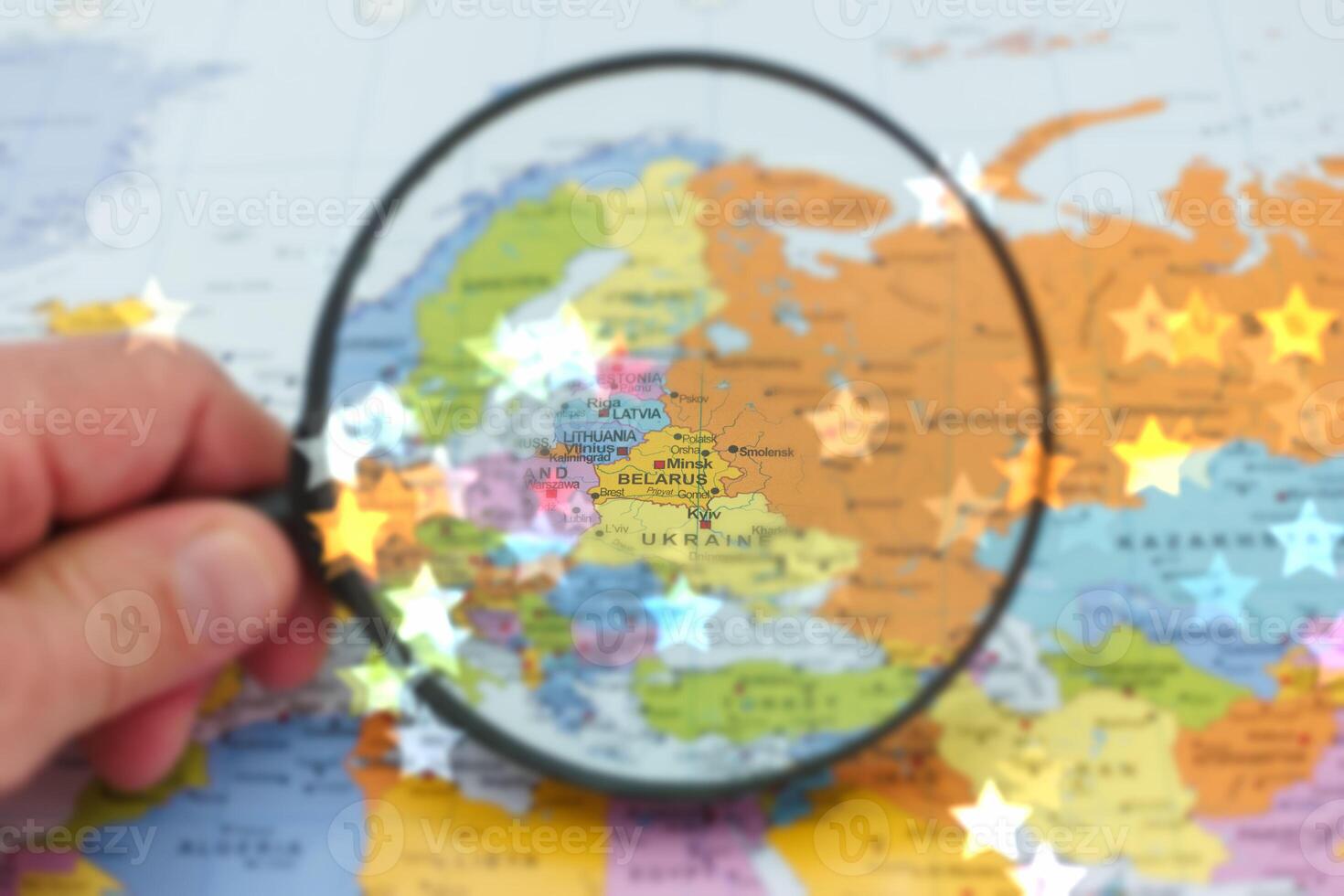Exploring Belarus on a detailed map using a magnifying glass to uncover geographical details in Eastern Europe photo