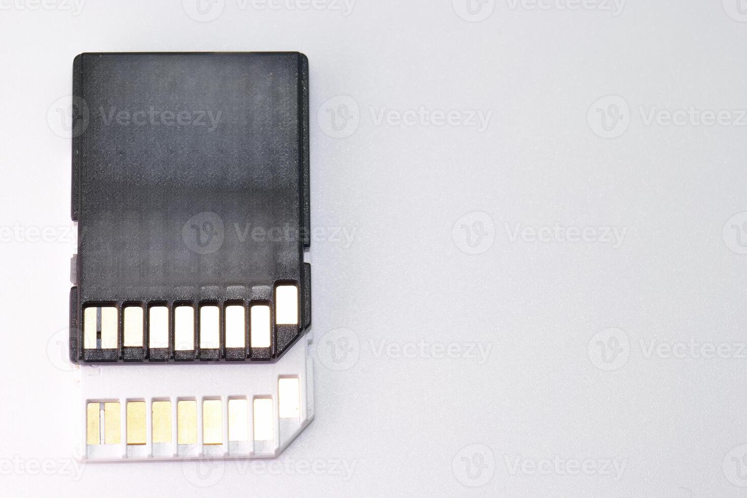 Memory card placed against a light surface highlighting its design and connection pins for data storage photo