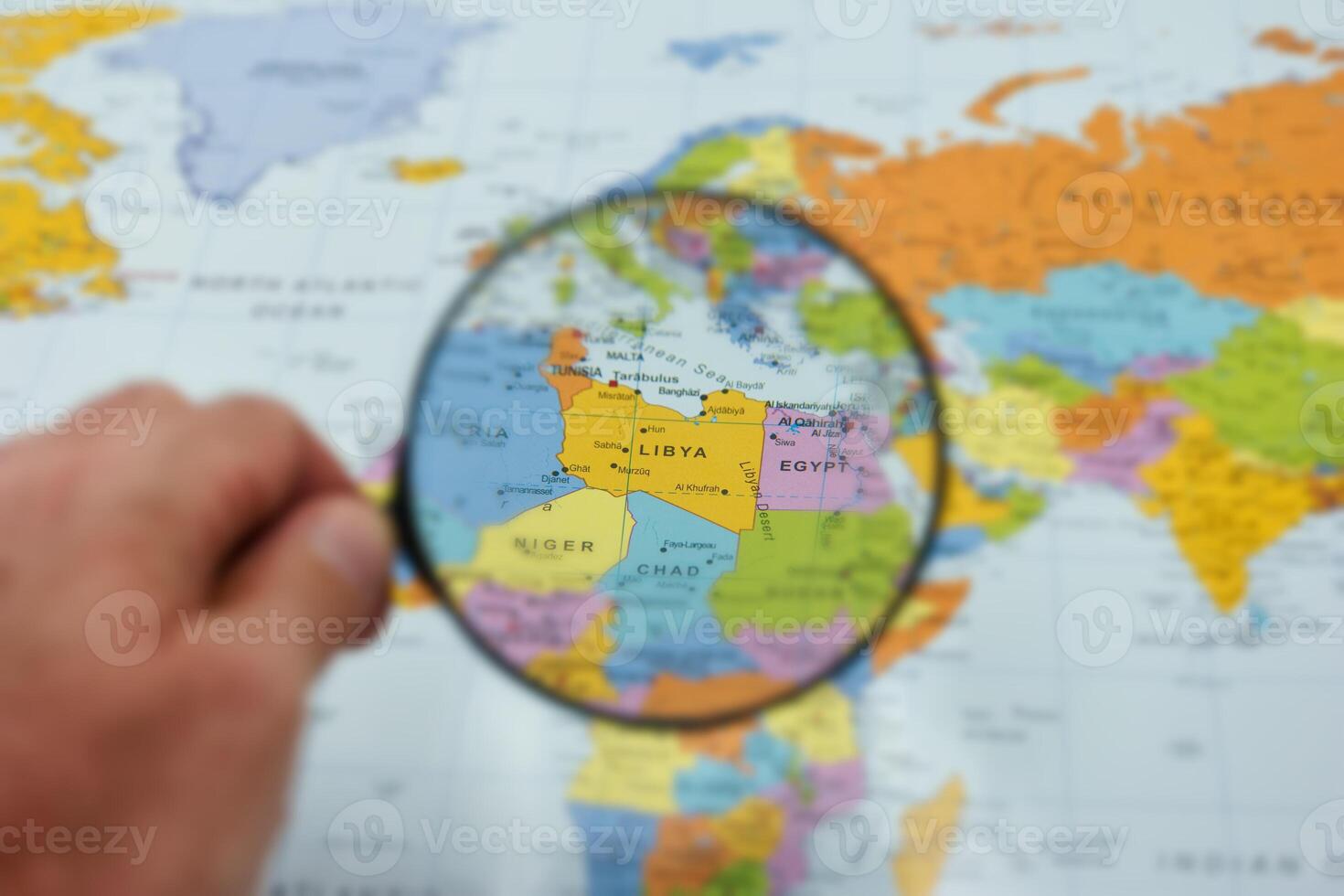 Exploring libya on a world map with a magnifying glass, highlighting geography and culture photo