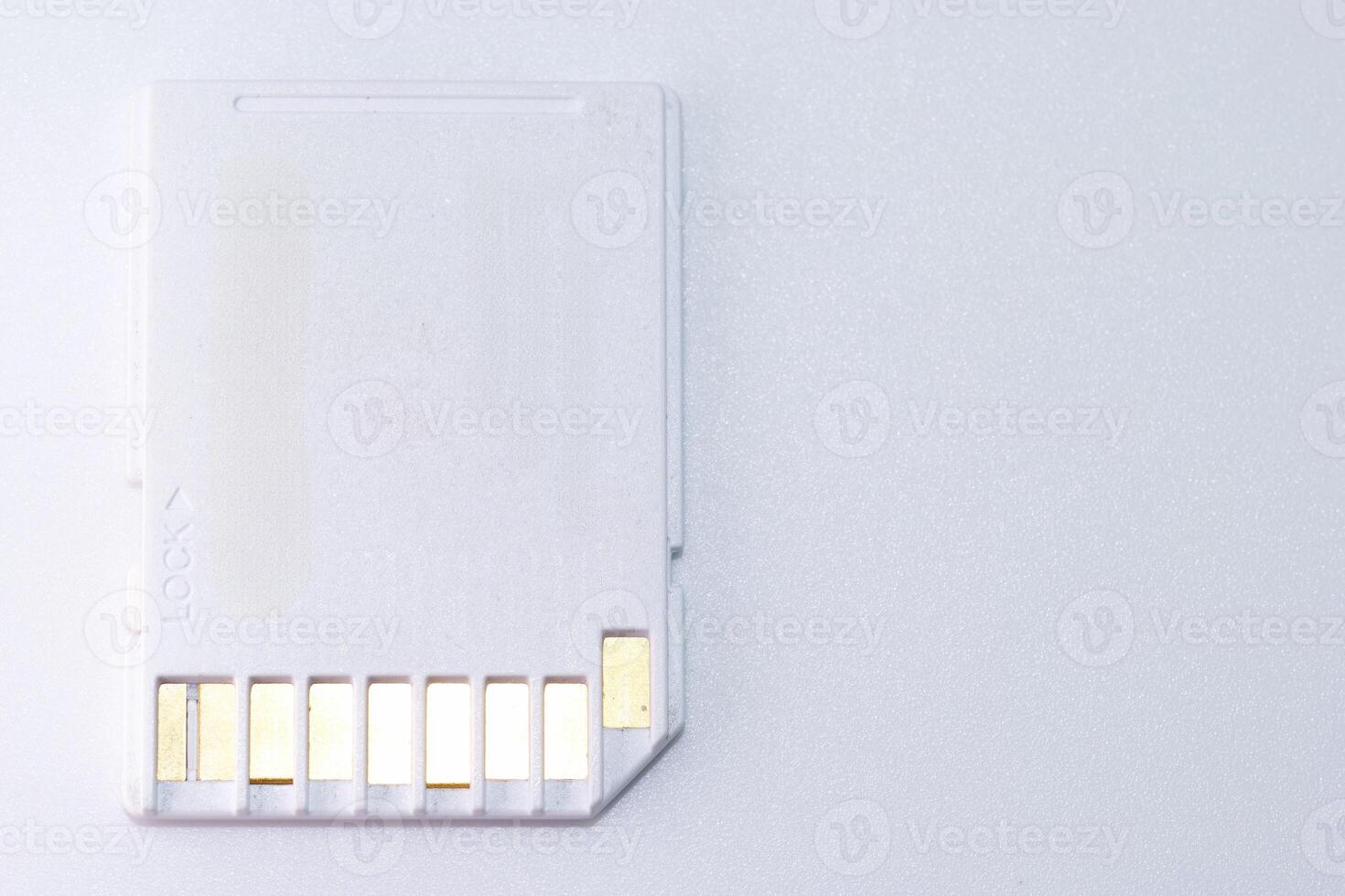 Memory card on a light background used for data storage in electronic devices like cameras and computers photo