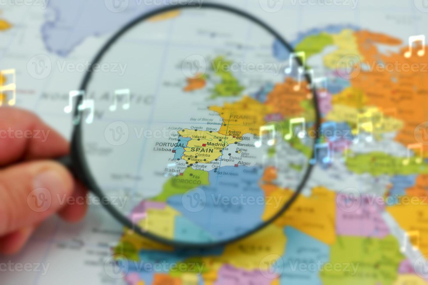 Exploring Spain on a map with a magnifying glass highlighting its geographical location in Europe photo
