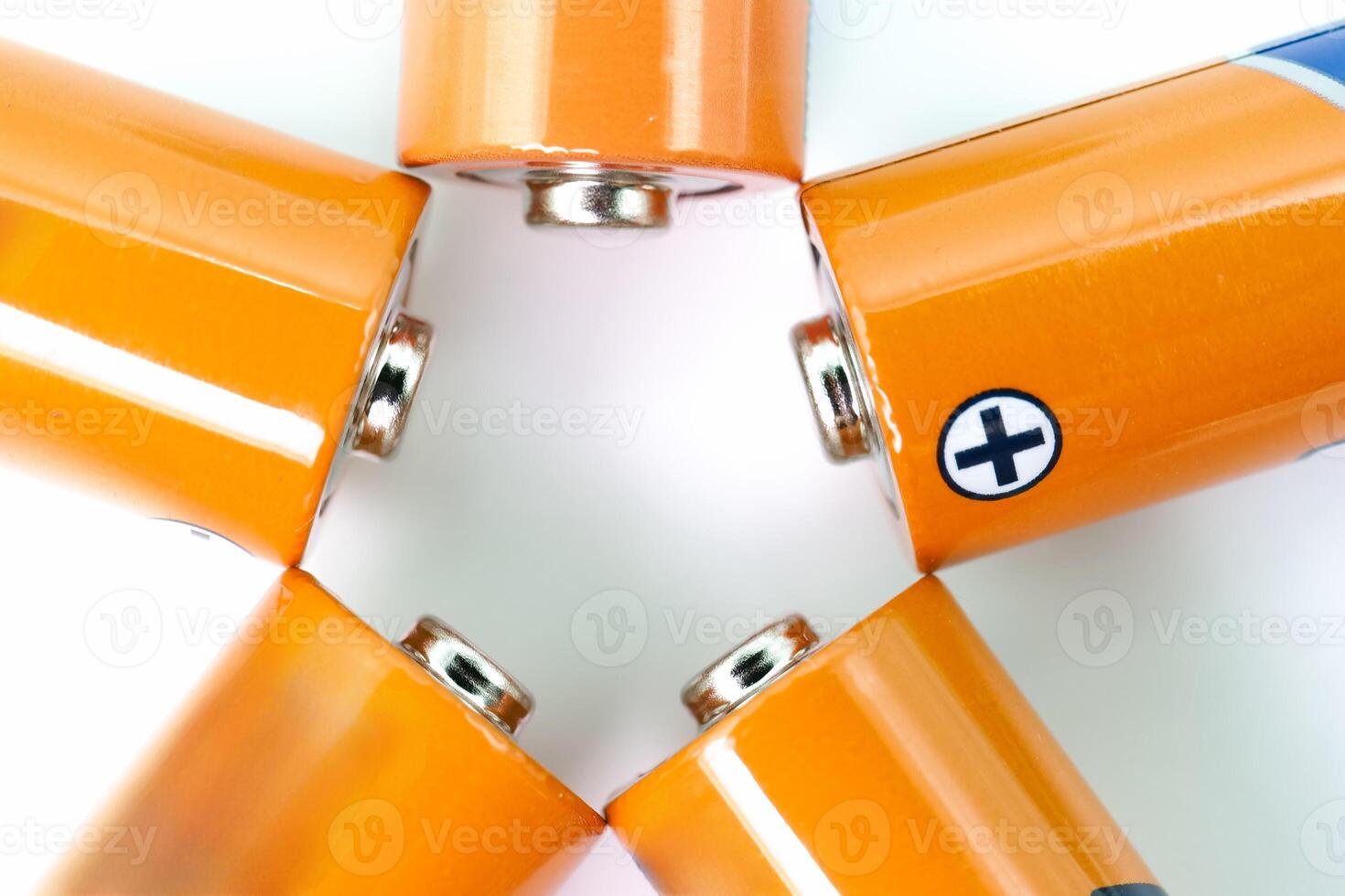 Batteries arranged in a star shape on a white surface showcasing their connectors and labels for a vibrant visual effect photo