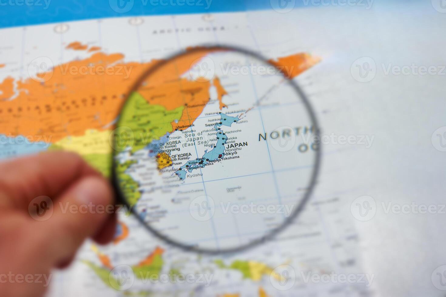 Exploring the geography of Asia with a magnifying glass over Korea and Japan on a colorful map photo