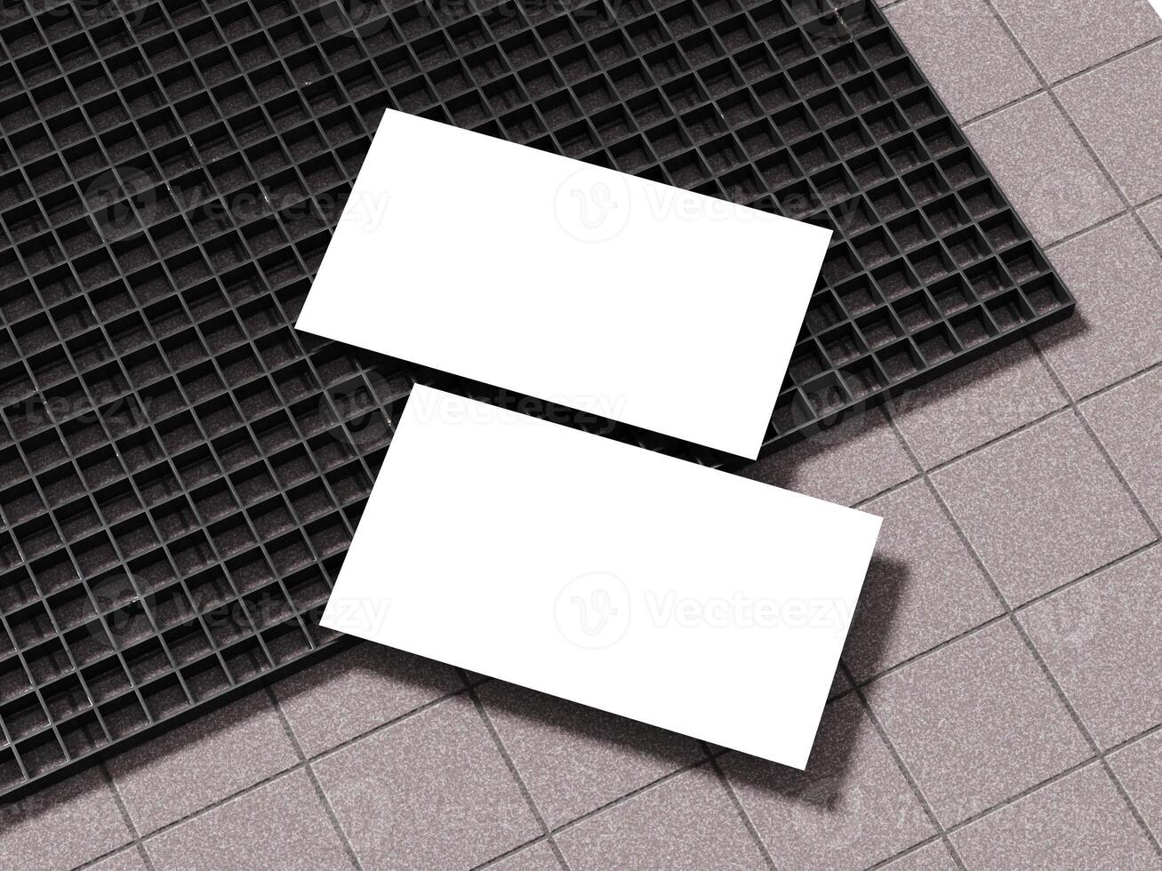 Business card positioned on textured concrete with black grid below. photo