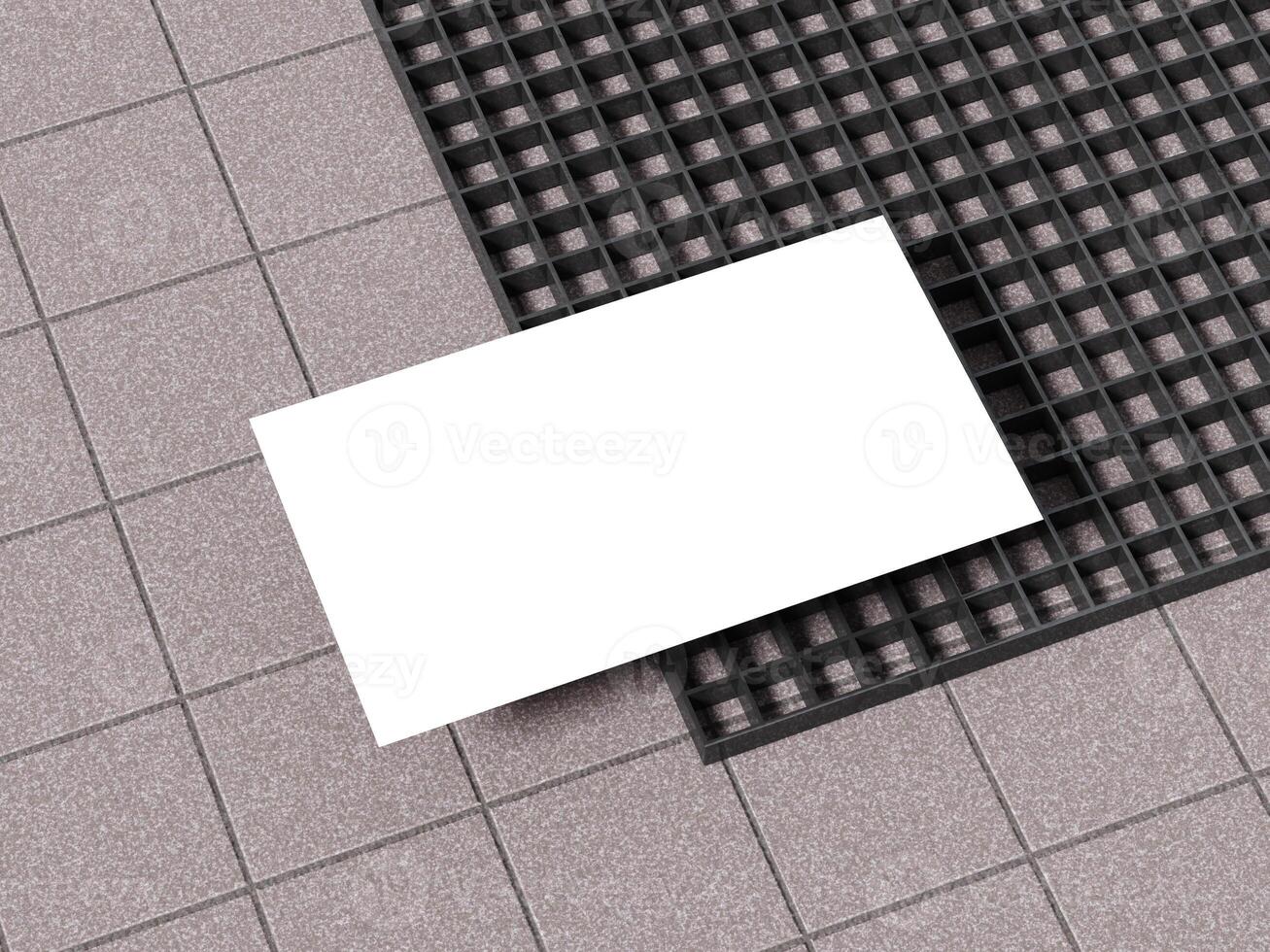 Business card mockup placed on a textured concrete floor with black grid pattern. photo