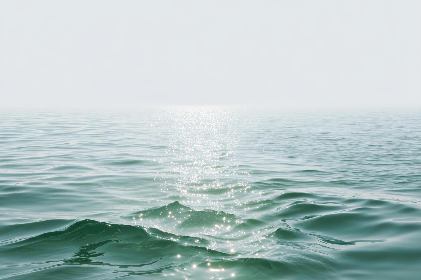 Peaceful ocean view with gentle waves and shimmering sunlight on the water surface photo