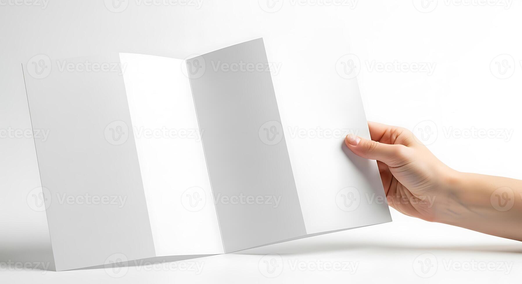Blank Brochure Held by Hand on White Background photo