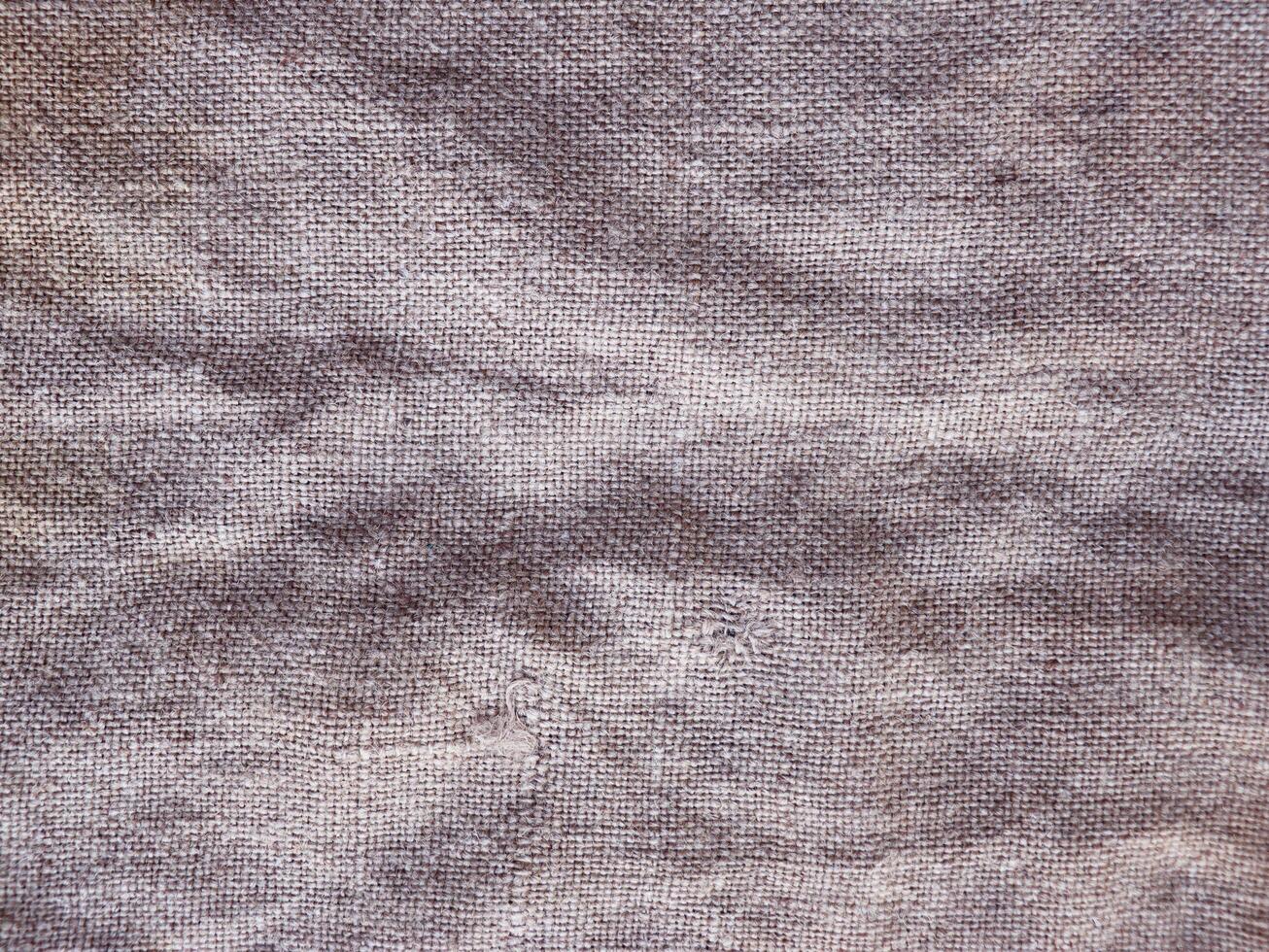 Rural texture of sackcloth. Background of very coarse, rough fabric woven made of flax, jute or hemp. Burlap bag material. Design element. photo