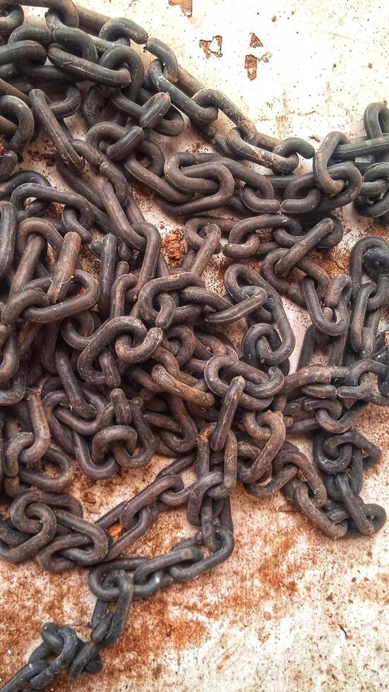 Top view of pile of old rusty chains photo