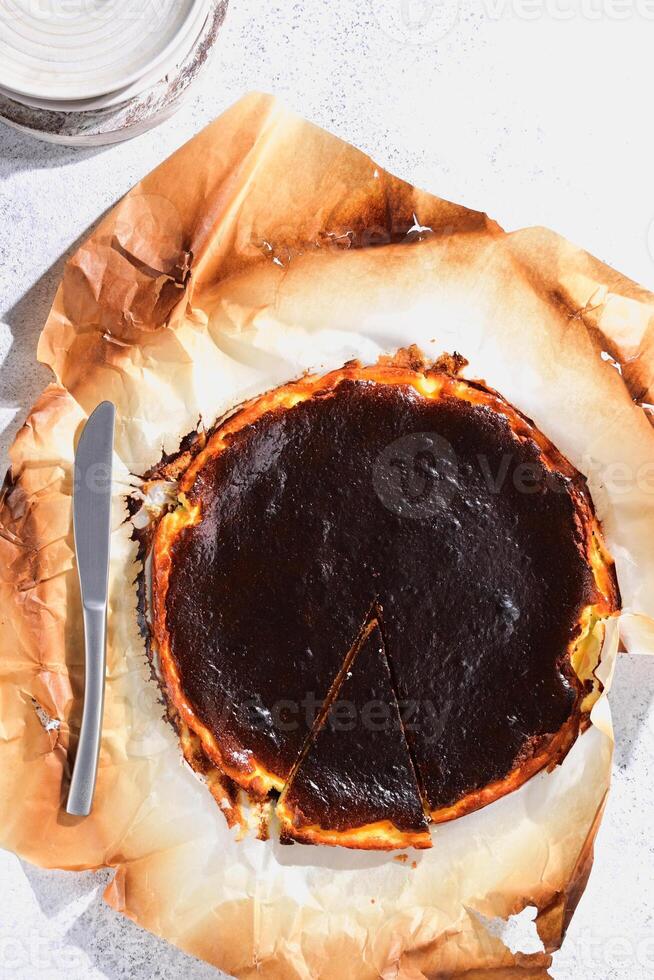A pie with a slice missing sits on top of a piece of paper photo