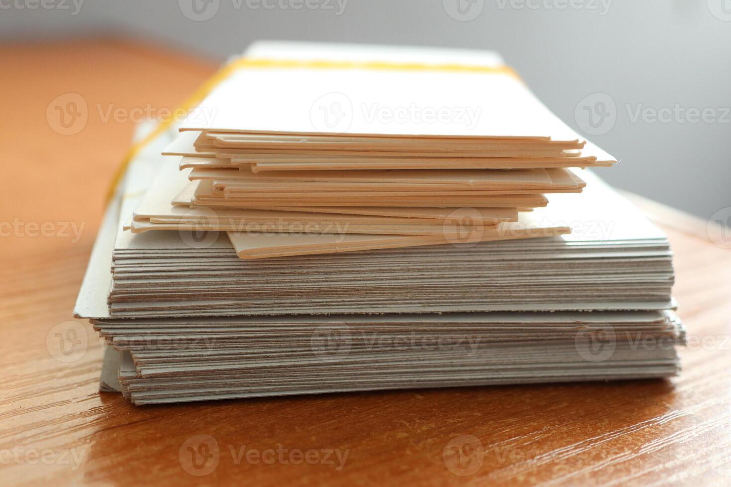 A Stack of Various Important Documents Neatly Organized and Arranged on a Wooden Table Surface photo