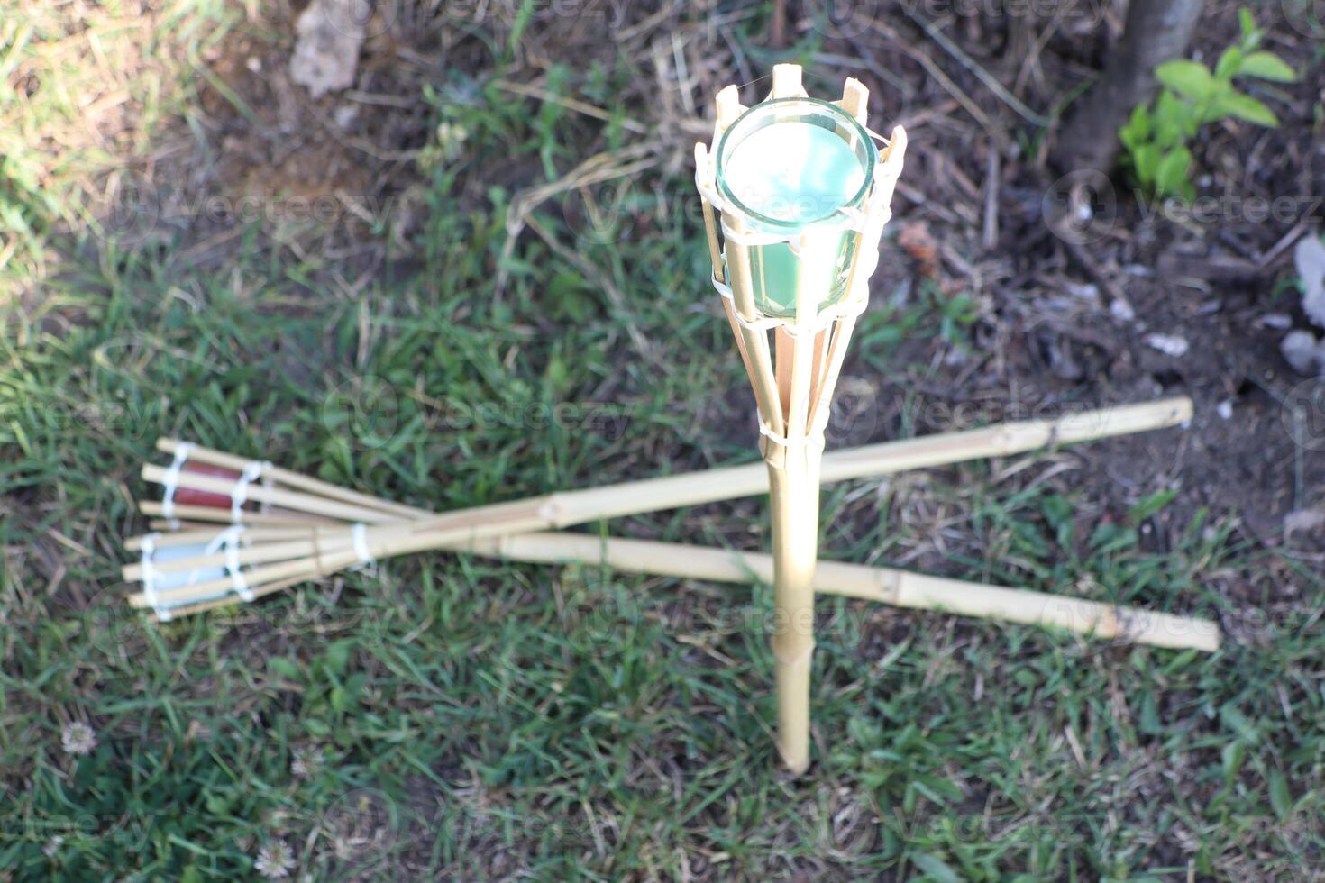 Bamboo Torches with elegant Green Lanterns beautifully enhance a captivating Garden scene photo