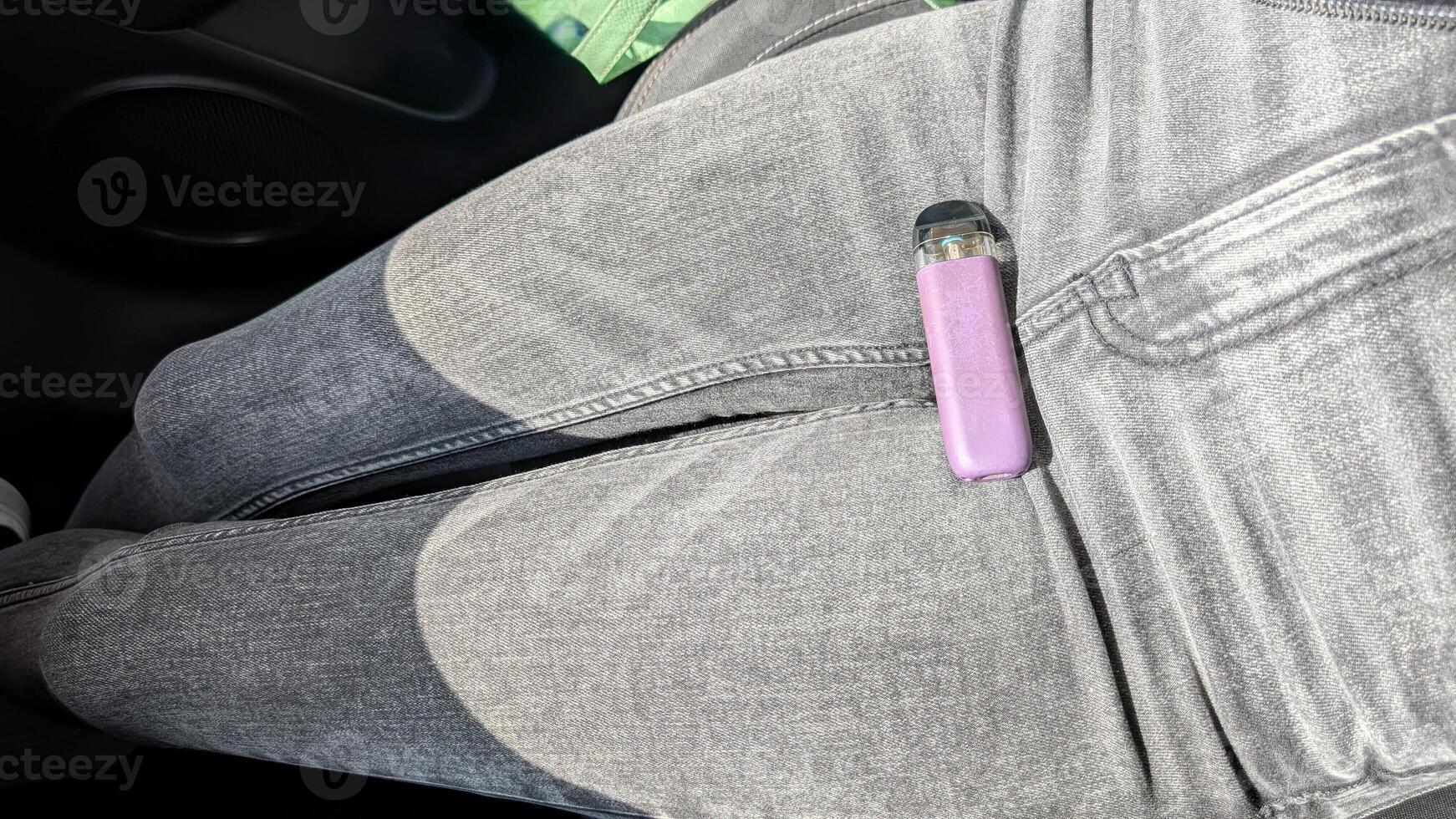 Discover the latest fashionable grey jeans perfectly paired with a trendy vape device photo