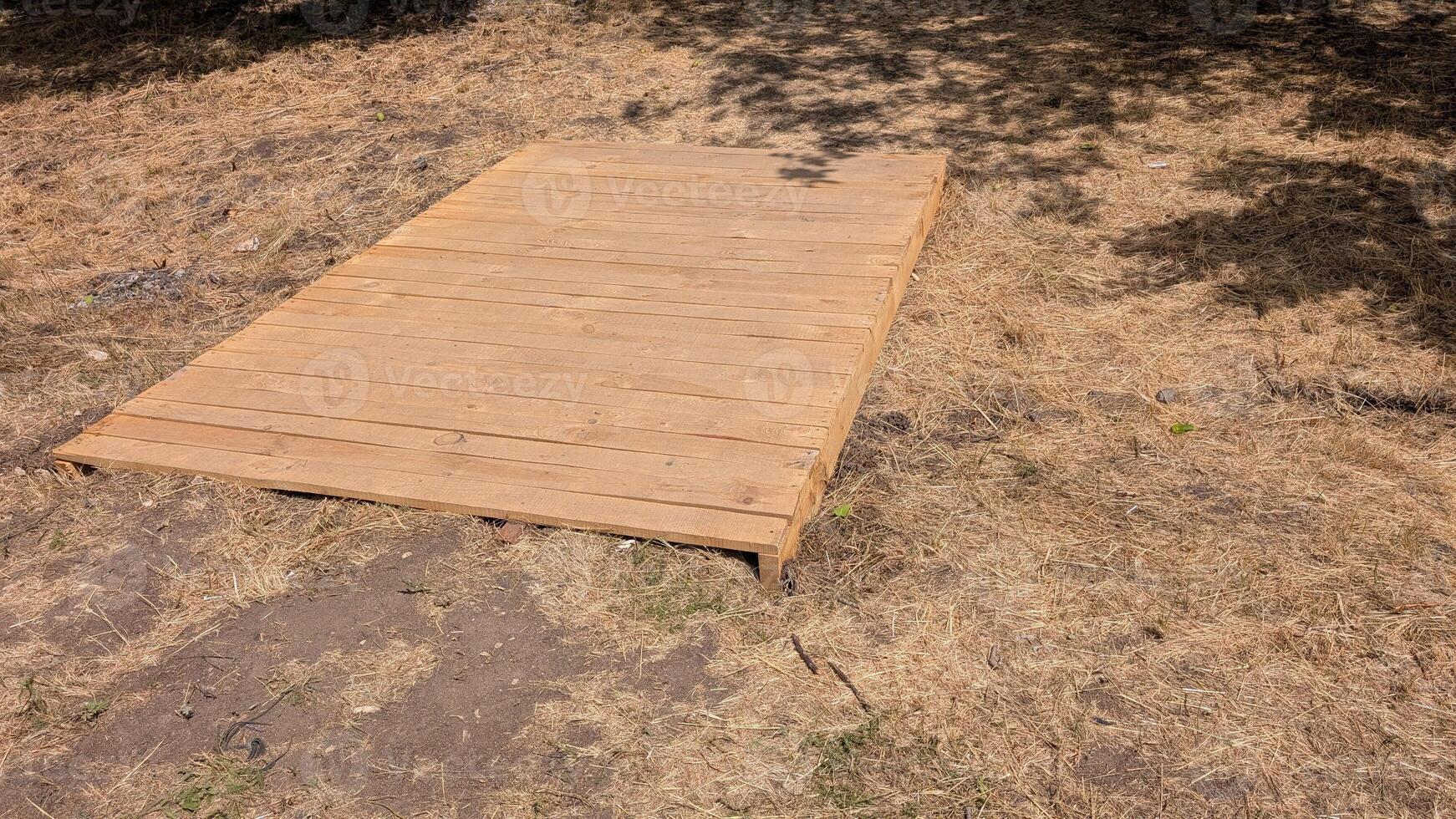 Wooden Deck Base Constructed on Dry Ground for Outdoor Relaxation and Recreational Use photo