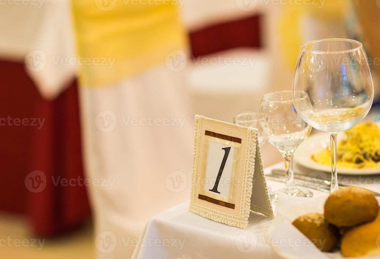 sign on restaurant table with empty dishes and glasses photo