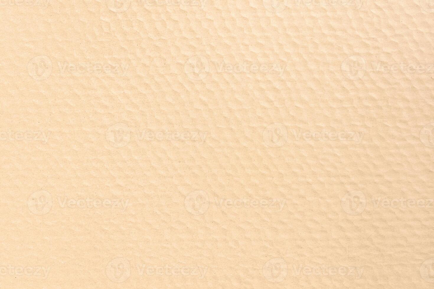 Brown textured cardboard abstract background forming a repeating pattern. Full frame photo