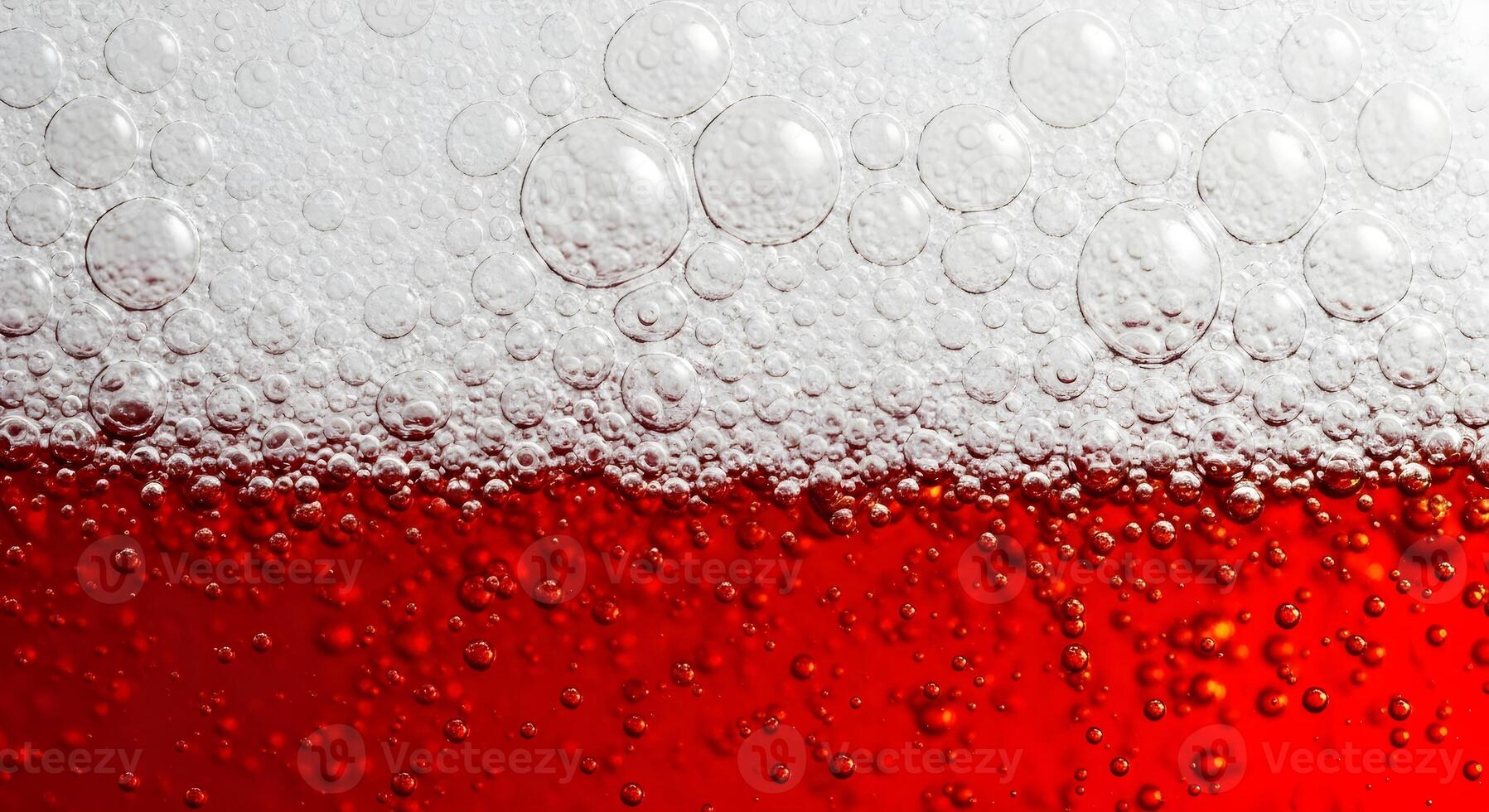 Red beer in a glass close-up, bubbles and beer foam. photo