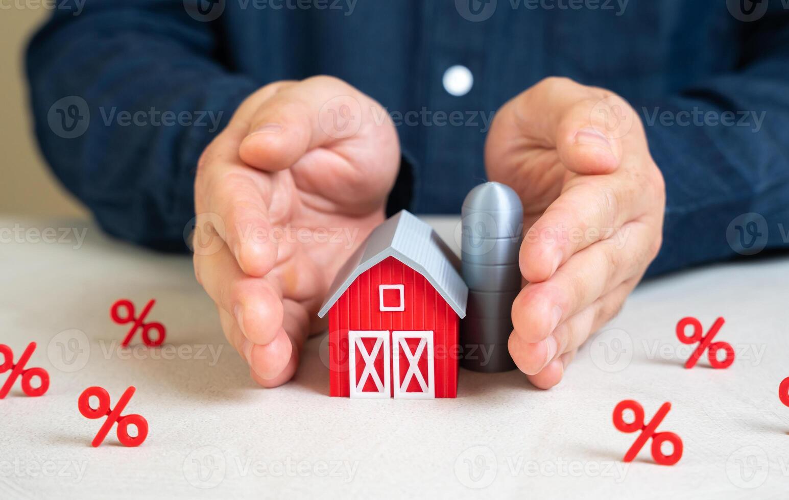 A man protects a farm barn from interest. High interest rates, taxes and costs are hurting the agro-industrial complex. Rising credit costs, fiscal burdens, and inflationary pressure in agriculture. photo