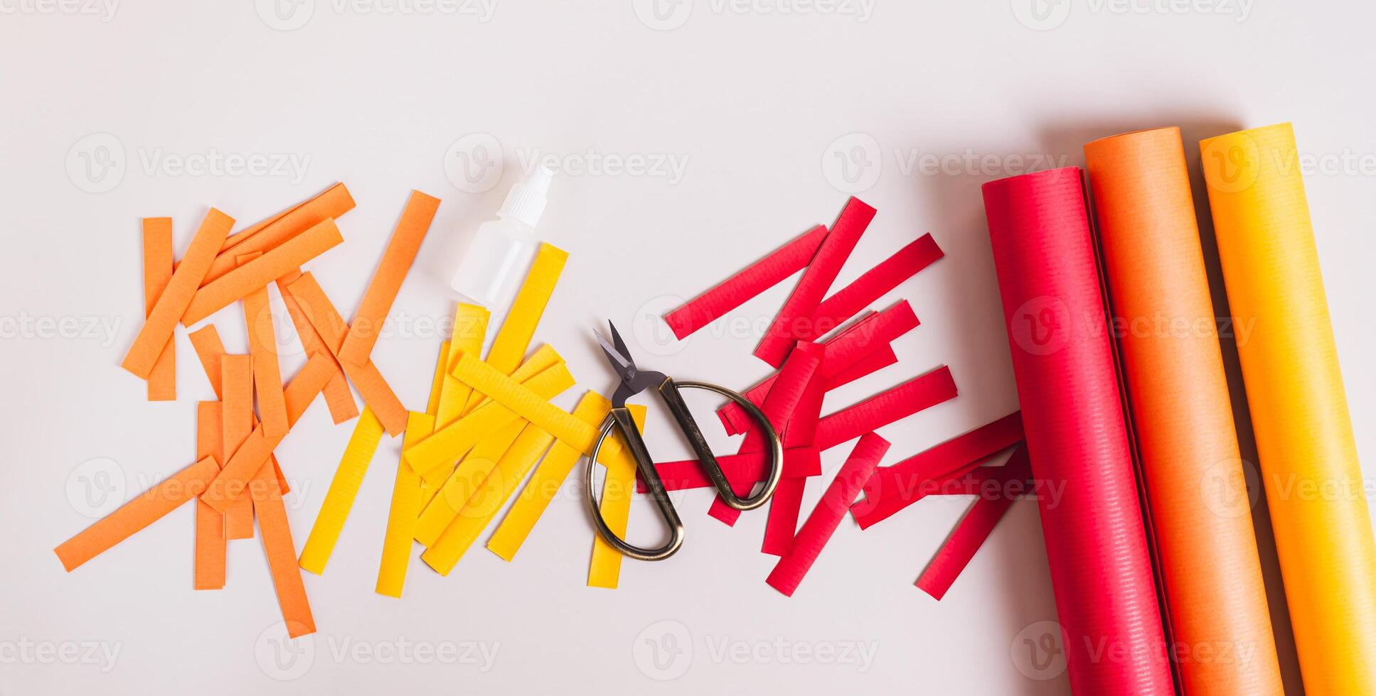 Strips of colored paper, scissors and glue to make paper garlands top view web banner photo